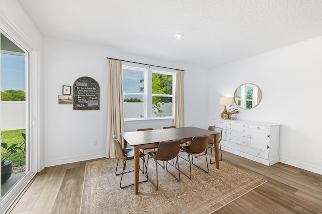 dining area featuring wood finished floors, baseboards, recessed lighting, and a textured ceiling
