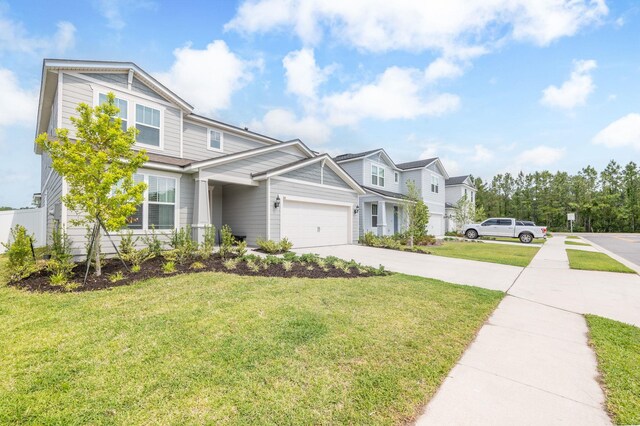 view of front facade featuring a garage, driveway, a front yard, and a residential view