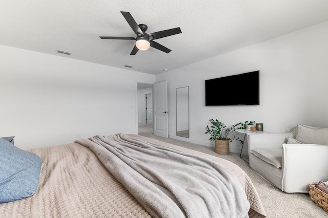 bedroom featuring a ceiling fan, light colored carpet, and baseboards