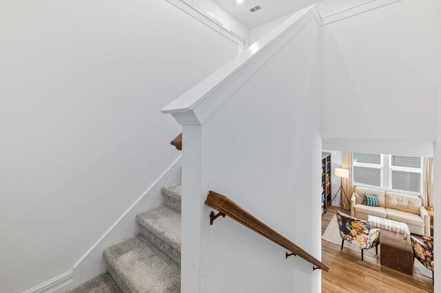 staircase featuring wood finished floors