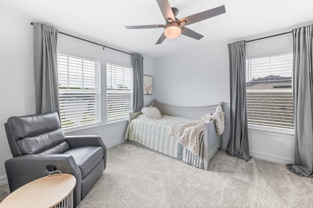 carpeted bedroom featuring baseboards and ceiling fan