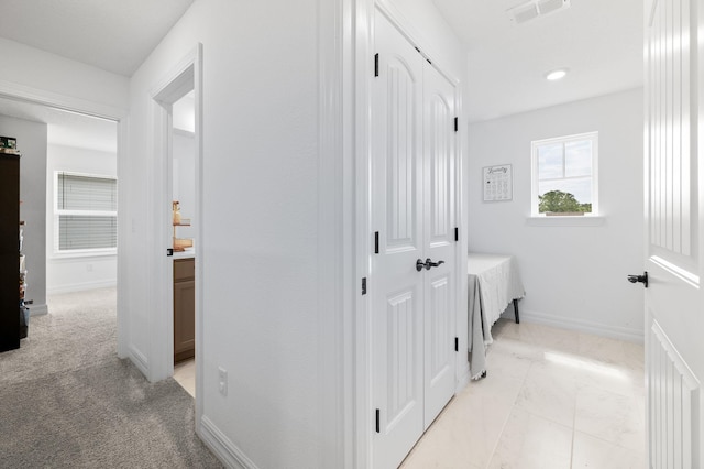 corridor featuring baseboards