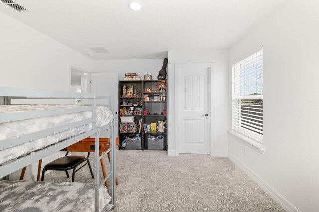 bedroom featuring carpet floors and baseboards
