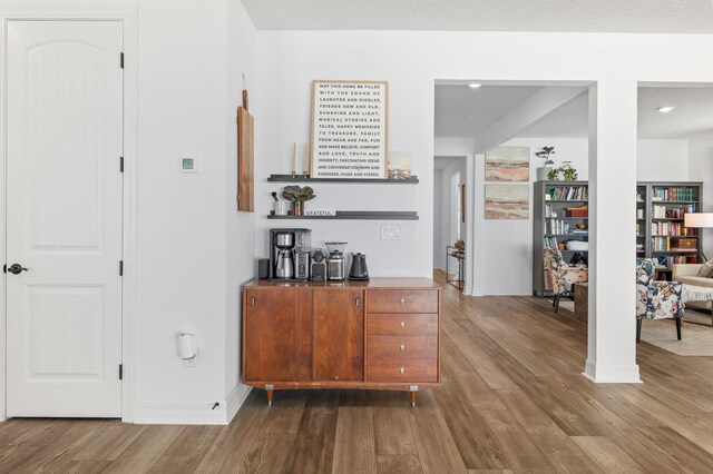 bar with wood finished floors, baseboards, and recessed lighting