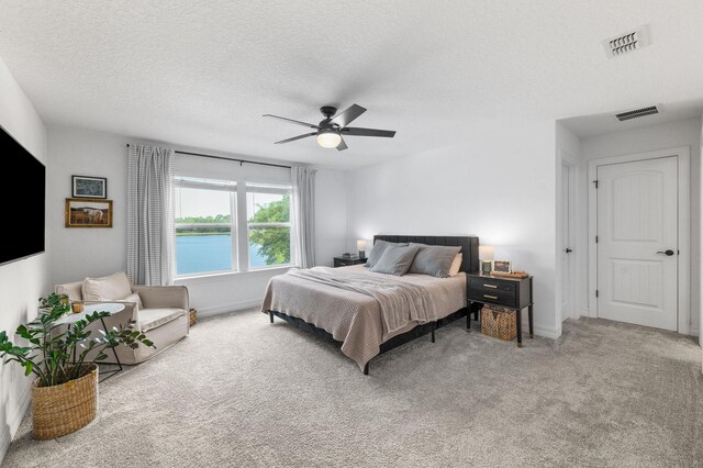 bedroom with carpet floors, a textured ceiling, a ceiling fan, and baseboards