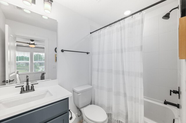 full bathroom featuring vanity, toilet, shower / tub combo, and a ceiling fan