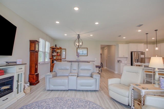 24 Pepperpike Way, Saint Augustine, FL 32092 - living room with light wood-style floors, baseboards, recessed lighting, and a chandelier
