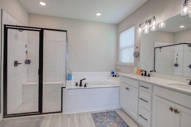 24 Pepperpike Way, Saint Augustine, FL 32092 - full bath featuring a stall shower, a garden tub, double vanity, wood finished floors, and recessed lighting