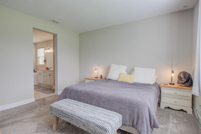 24 Pepperpike Way, Saint Augustine, FL 32092 - bedroom with light colored carpet, baseboards, and connected bathroom