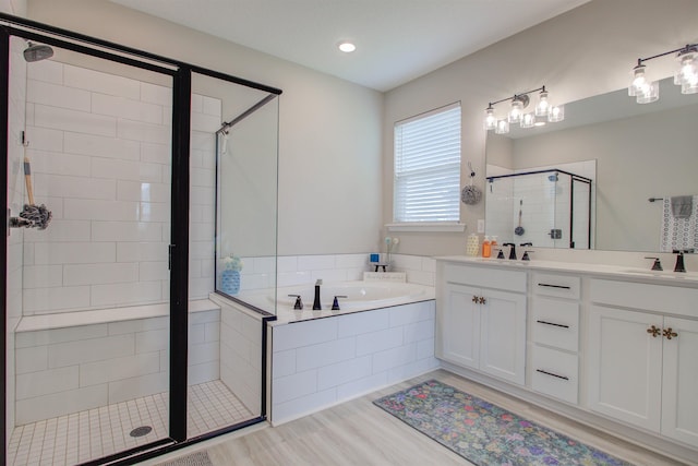 24 Pepperpike Way, Saint Augustine, FL 32092 - bathroom with a stall shower, a bath, double vanity, and wood finished floors