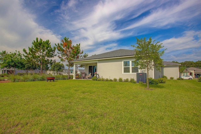 24 Pepperpike Way, Saint Augustine, FL 32092 - back of property with a lawn, a fire pit, and central AC unit