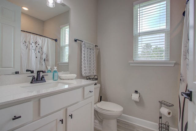 24 Pepperpike Way, Saint Augustine, FL 32092 - full bath featuring baseboards, vanity, toilet, wood finished floors, and curtained shower