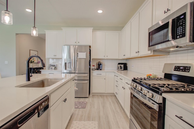 24 Pepperpike Way, Saint Augustine, FL 32092 - kitchen with appliances with stainless steel finishes, a sink, light countertops, white cabinets, and recessed lighting