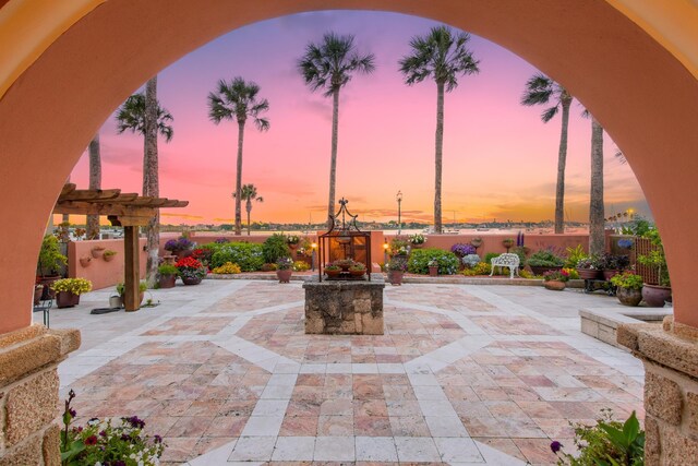 back house at dusk featuring french doors, a balcony, and ceiling fan