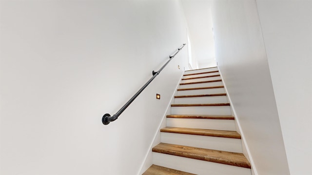 stairway featuring hardwood / wood-style flooring