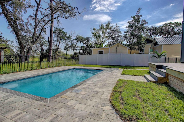 view of swimming pool with a yard