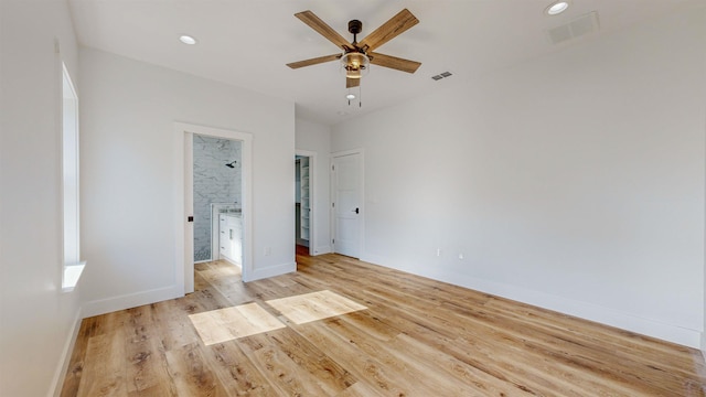 unfurnished bedroom featuring ceiling fan, light hardwood / wood-style flooring, and ensuite bathroom