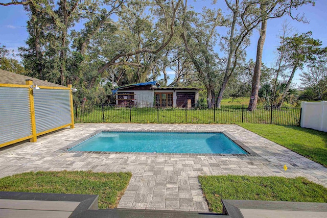 view of swimming pool with a lawn and a patio