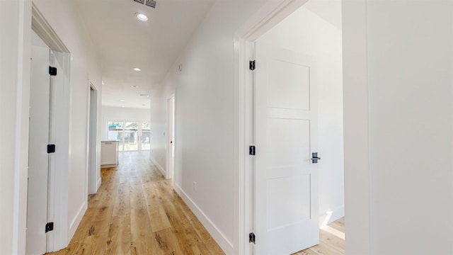 hall with light hardwood / wood-style flooring