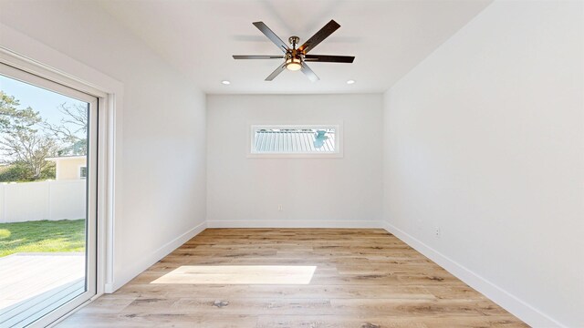 unfurnished living room featuring ceiling fan, light wood-type flooring, and a wealth of natural light