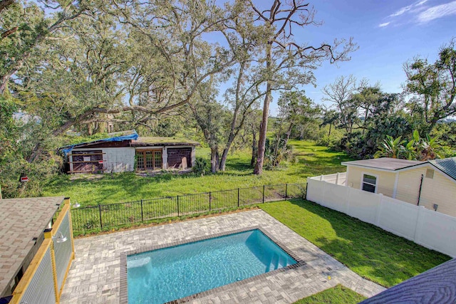 view of swimming pool featuring a patio area and a yard