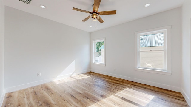 empty room with ceiling fan and light wood-type flooring