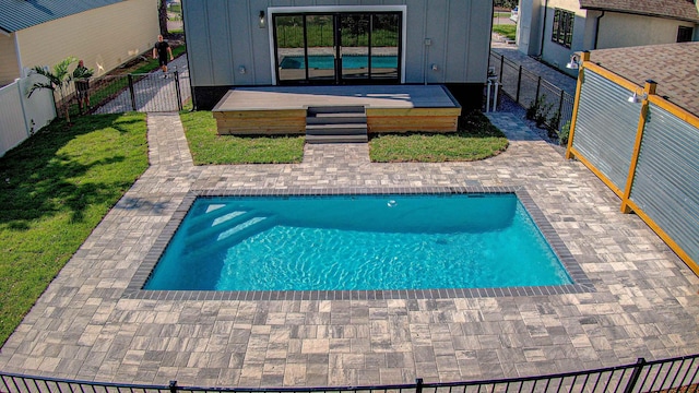 view of swimming pool with a patio and a wooden deck