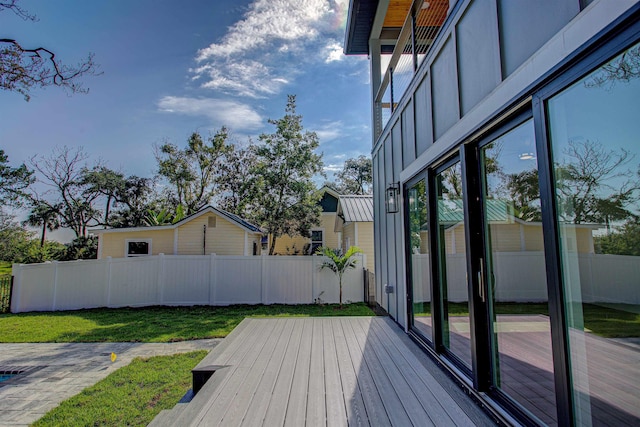 wooden terrace featuring a yard