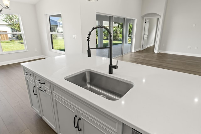 kitchen with dark hardwood / wood-style flooring, sink, and white cabinetry