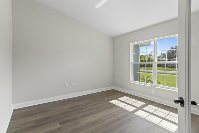 unfurnished room with dark wood-type flooring