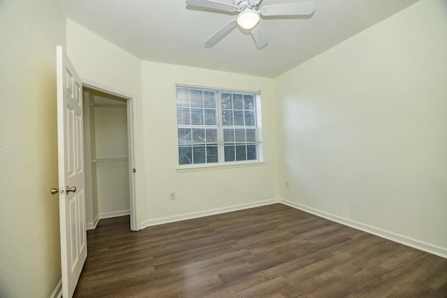 unfurnished bedroom with ceiling fan and dark hardwood / wood-style flooring