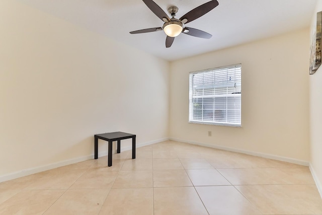 spare room with ceiling fan and light tile patterned flooring