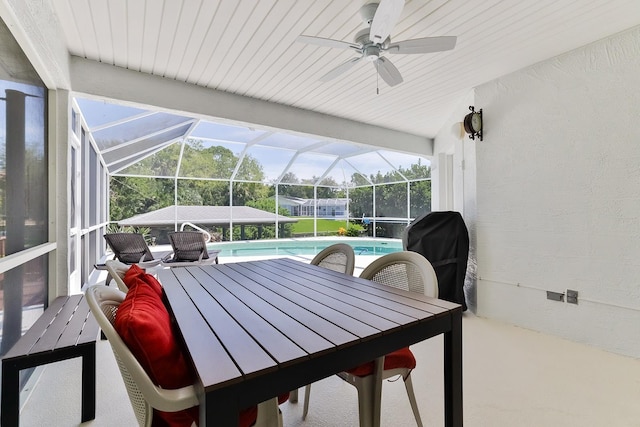 sunroom / solarium featuring ceiling fan, plenty of natural light, lofted ceiling, and a pool