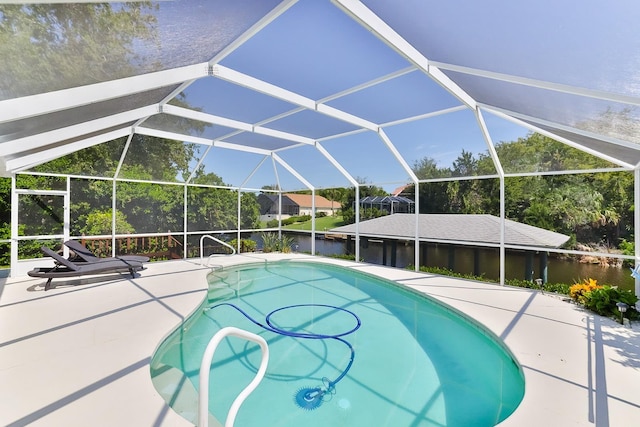 view of swimming pool with a water view, glass enclosure, and a patio area