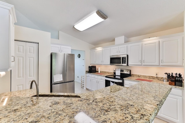 kitchen with white cabinetry, sink, stainless steel appliances, light stone counters, and lofted ceiling