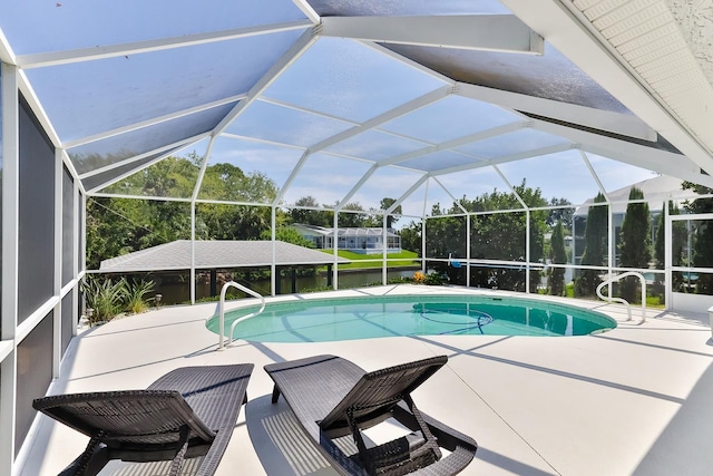 view of swimming pool featuring a patio and a lanai