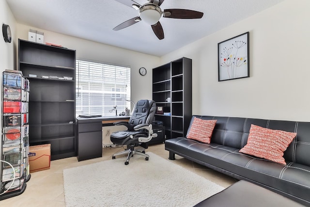 tiled office space featuring ceiling fan and a textured ceiling