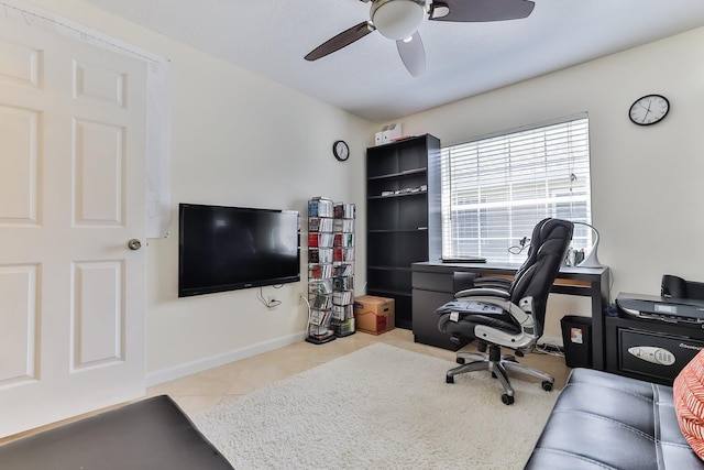 tiled home office featuring ceiling fan