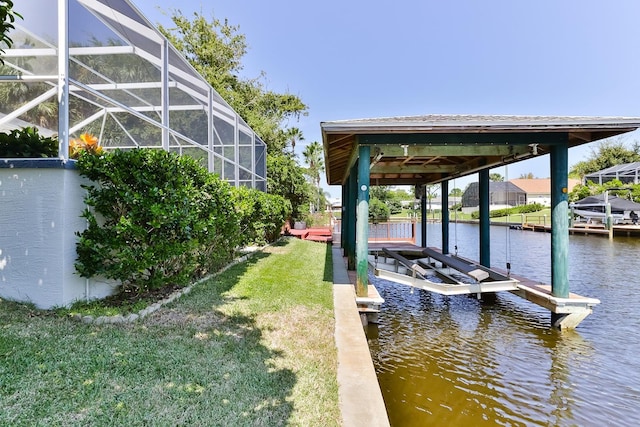 dock area featuring a yard, a water view, and a lanai