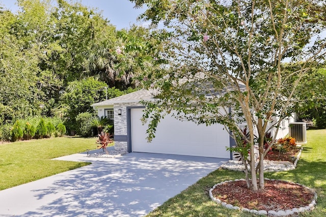 view of front of property with a front lawn, a garage, and cooling unit