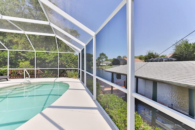 view of swimming pool featuring a water view and glass enclosure