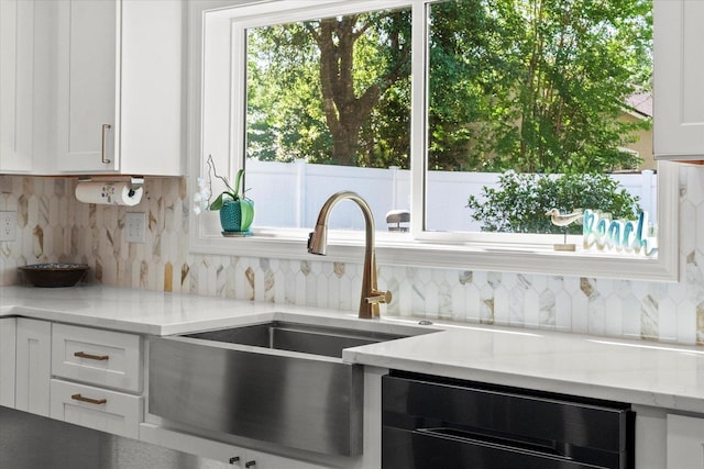 1430 River Of May St, Saint Augustine, FL 32092 - kitchen with white cabinets, dishwashing machine, and decorative backsplash