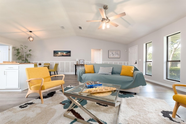 living area with vaulted ceiling, ceiling fan, and wood finished floors
