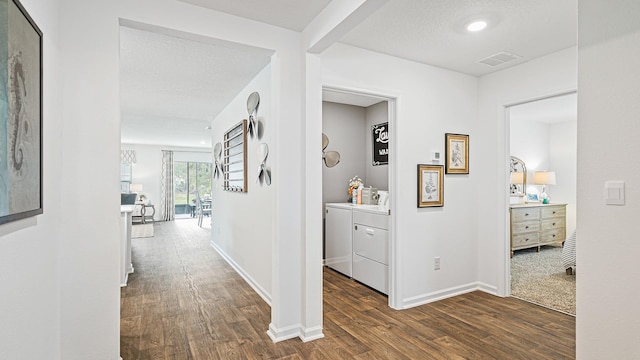 hall with washing machine and dryer, dark wood-style floors, and baseboards