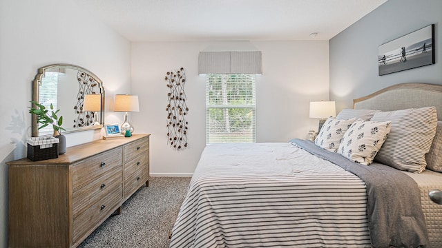 bedroom with carpet flooring and baseboards