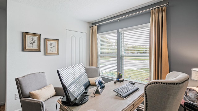 office area with healthy amount of natural light and a textured ceiling
