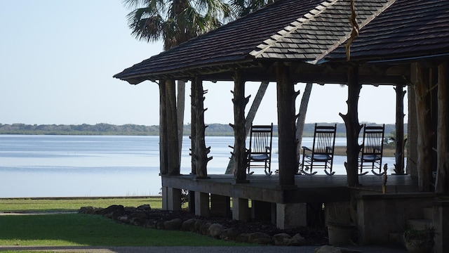 dock area featuring a gazebo, a water view, and a yard