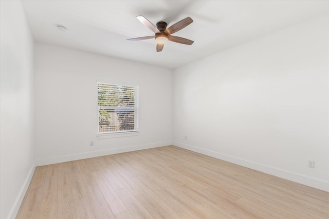 spare room featuring light hardwood / wood-style floors and ceiling fan