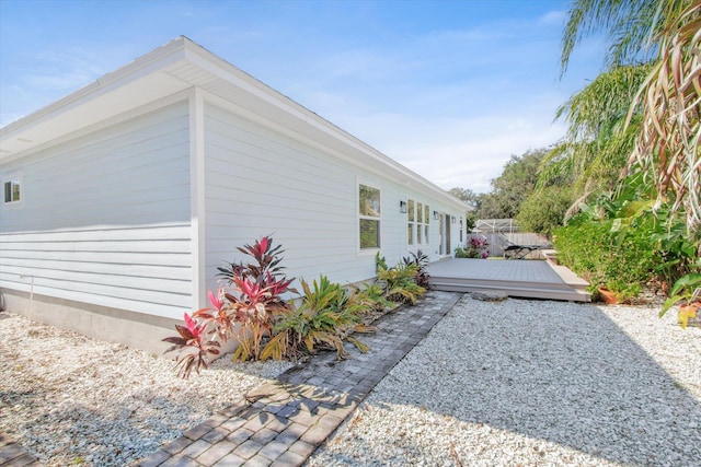 view of side of home featuring a wooden deck