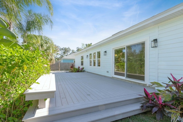 wooden terrace featuring fence